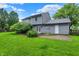 Backyard with green grass, blue sky, privacy fence, and a patio area at 7430 Railway Ct, Indianapolis, IN 46256