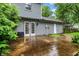 Wet patio in the backyard with french doors leading to the home and a privacy fence at 7430 Railway Ct, Indianapolis, IN 46256