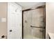 Bathroom featuring a sliding glass shower door, white trim, and tiled walls at 7430 Railway Ct, Indianapolis, IN 46256