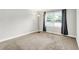 Bedroom with carpet, large window with curtains, and a floor lamp at 7430 Railway Ct, Indianapolis, IN 46256