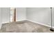 Carpeted bedroom with a view into the hall. Includes a floor lamp at 7430 Railway Ct, Indianapolis, IN 46256