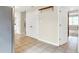 Hallway featuring tile flooring, white trim, and doors with a glimpse into an adjacent room at 7430 Railway Ct, Indianapolis, IN 46256