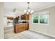 Open concept kitchen and eat-in dining area with bright natural light and matching cabinetry at 7430 Railway Ct, Indianapolis, IN 46256