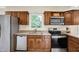 Kitchen with stainless steel appliances, tile flooring and natural light coming through the window at 7430 Railway Ct, Indianapolis, IN 46256
