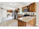 Kitchen with stainless steel appliances, breakfast bar and open view to living room at 7430 Railway Ct, Indianapolis, IN 46256