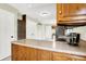 Kitchen with a breakfast bar, leading into an open-concept dining and living area at 7430 Railway Ct, Indianapolis, IN 46256
