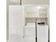Convenient laundry area featuring a washer, dryer, and shelving, maximizing space and functionality at 7430 Railway Ct, Indianapolis, IN 46256