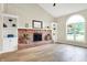 Bright living room features a brick fireplace with built-ins and a large window at 7430 Railway Ct, Indianapolis, IN 46256