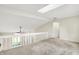 Bright loft with natural light, skylight, and open railing offers a versatile and inviting space at 7430 Railway Ct, Indianapolis, IN 46256