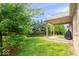 A backyard with grass, trees and a covered patio at 745 Ridge Gate Dr, Brownsburg, IN 46112