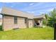 Brick exterior of the house with a well-maintained lawn, a covered patio and an outdoor grill for entertaining at 745 Ridge Gate Dr, Brownsburg, IN 46112