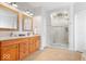 Bright bathroom features a double vanity, modern mirrors and a glass-enclosed walk-in shower with tiled surround at 745 Ridge Gate Dr, Brownsburg, IN 46112