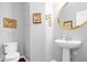 A half-bath features a pedestal sink with framed art at 745 Ridge Gate Dr, Brownsburg, IN 46112