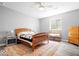 A neutral bedroom features a bed with wood trim and a patterned rug at 745 Ridge Gate Dr, Brownsburg, IN 46112