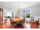 Bright dining area featuring hardwood floors, chair railing, and a sunny window view at 745 Ridge Gate Dr, Brownsburg, IN 46112