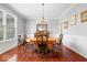 Traditional dining room with hardwood floors, chandelier, wainscotting, and natural light at 745 Ridge Gate Dr, Brownsburg, IN 46112