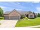 Brick ranch home with a three-car garage, well-kept lawn and manicured landscaping at 745 Ridge Gate Dr, Brownsburg, IN 46112