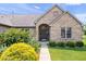 Up-close shot of the home's entry, showcasing detailed brickwork and lush landscaping at 745 Ridge Gate Dr, Brownsburg, IN 46112