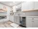 Basement kitchenette features modern white cabinetry, granite countertops, a microwave, and a beverage refrigerator at 745 Ridge Gate Dr, Brownsburg, IN 46112