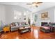 Inviting living room featuring hardwood floors, columns, fireplace and natural lighting at 745 Ridge Gate Dr, Brownsburg, IN 46112
