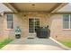Covered patio features brick exterior, a grill, and an outdoor dining area, ideal for enjoying outdoor meals and relaxation at 745 Ridge Gate Dr, Brownsburg, IN 46112