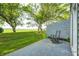 Backyard featuring a patio, green grass, and mature trees at 7507 Choate Ct, Indianapolis, IN 46254