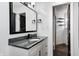 Updated bathroom featuring a granite countertop vanity, beadboard wall paneling, and stylish mirror at 7507 Choate Ct, Indianapolis, IN 46254