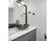 Modern bathroom with a sleek glass bowl sink, gray vanity, and unique fixtures at 7507 Choate Ct, Indianapolis, IN 46254