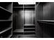 Walk-in closet with dark wood shelving and ample storage space for an organized wardrobe at 7507 Choate Ct, Indianapolis, IN 46254