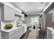 Updated kitchen with stainless steel appliances, light gray cabinets, a table with chairs, and hardwood floors at 7507 Choate Ct, Indianapolis, IN 46254