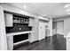 Bright kitchen featuring white cabinets, stainless steel appliances, a workspace, and hardwood floors at 7507 Choate Ct, Indianapolis, IN 46254