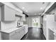 Modern kitchen featuring light gray cabinets, stainless steel appliances, and hardwood floors at 7507 Choate Ct, Indianapolis, IN 46254