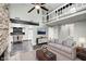 Open-concept living room with fireplace, loft, and view into kitchen at 7507 Choate Ct, Indianapolis, IN 46254