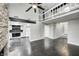 Bright open-concept living room featuring a stone fireplace, loft, and hardwood floors at 7507 Choate Ct, Indianapolis, IN 46254