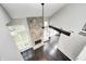 Bright living room with a stone fireplace, hardwood floors, and abundant natural light at 7507 Choate Ct, Indianapolis, IN 46254