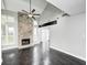 Spacious living room featuring a stone fireplace, vaulted ceilings, and dark hardwood floors at 7507 Choate Ct, Indianapolis, IN 46254
