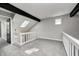 Spacious loft featuring skylight, dark beams, carpet flooring and white railing at 7507 Choate Ct, Indianapolis, IN 46254