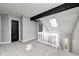 Cozy loft area with skylight, black beam, and white railings overlooking the living space at 7507 Choate Ct, Indianapolis, IN 46254