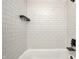 Bathroom shower showcasing bright white subway tile and black fixtures at 7507 Choate Ct, Indianapolis, IN 46254