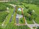 Aerial view of a large property with two houses, mature trees, and expansive green spaces, perfect for country living at 7850 S Mooresville Rd, Indianapolis, IN 46113