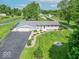 Aerial view of a charming home with a well-manicured lawn, lush landscaping, and a paved driveway at 7850 S Mooresville Rd, Indianapolis, IN 46113