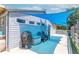 A cozy backyard space with a blue shade sail, a grill, and outdoor seating, perfect for relaxation at 7850 S Mooresville Rd, Indianapolis, IN 46113