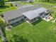 Aerial view of a large backyard with a covered patio, outdoor seating, and lush greenery at 7850 S Mooresville Rd, Indianapolis, IN 46113
