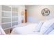Bright bedroom with a cozy bed, soft lighting, and a minimalist aesthetic with decorative hats hanging on the wall at 7850 S Mooresville Rd, Indianapolis, IN 46113