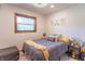 Bright bedroom with a comfortable bed, side table, modern light fixture and decor at 7850 S Mooresville Rd, Indianapolis, IN 46113