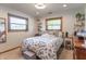 Bright bedroom featuring natural light, stylish decor, and a comfortable bed with a decorative throw blanket at 7850 S Mooresville Rd, Indianapolis, IN 46113