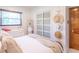 Cozy bedroom with warm lighting, a decorative mirror, and a comfortable bed with stylish bedding at 7850 S Mooresville Rd, Indianapolis, IN 46113