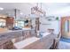 Open-concept dining area with a long wooden table, seating for eight, and kitchen views at 7850 S Mooresville Rd, Indianapolis, IN 46113