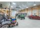 Spacious garage featuring a car, utility vehicle, and mezzanine, providing ample storage and parking at 7850 S Mooresville Rd, Indianapolis, IN 46113
