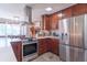 A spacious kitchen features stainless steel appliances, including a range hood, with ample counter space at 7850 S Mooresville Rd, Indianapolis, IN 46113